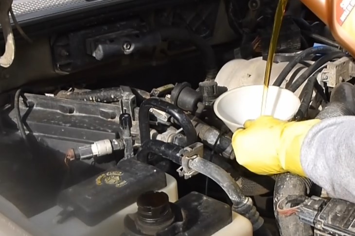 Osoba doliva ulja u motor automobila