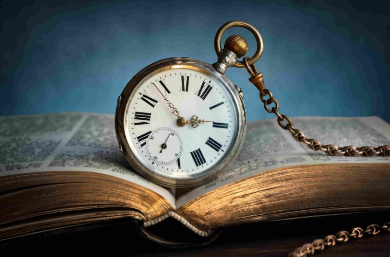 Starinski džepni sat na otvorenoj knjizi